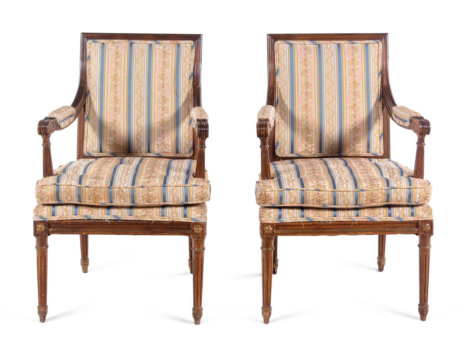 A Pair of Louis XVI Style Walnut Fauteuils