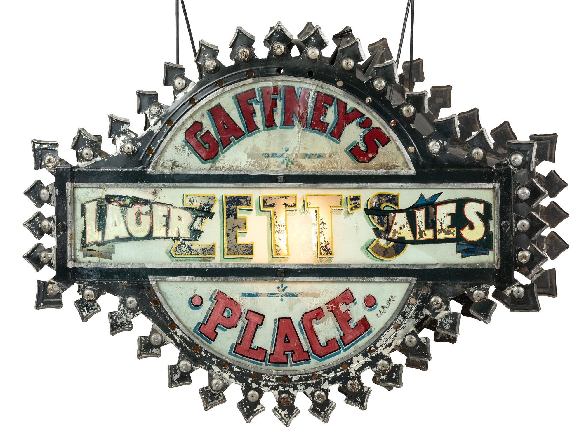 A Zett's Lager and Ales Reverse Painted Glass and Pressed Metal Double-Sided Lighted Bar Sign