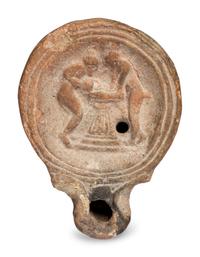 A Roman Terracotta Oil Lamp with Two Women