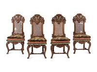 A Set of Four William and Mary Style Caned and Pierced-Carved Walnut Dining Chairs
