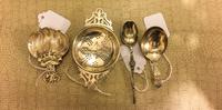 A Group of Four Victorian Silver Tea Articles, Various makers, comprising a tea strainer, two tea scoops and a teaspoon.