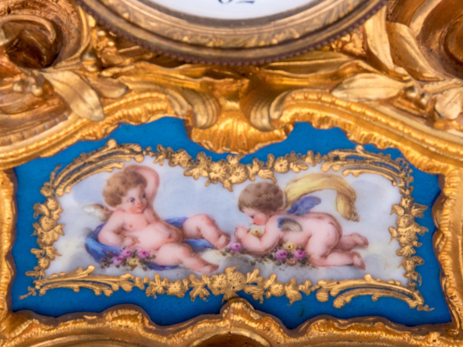 A Louis XV Style Porcelain Mounted Gilt Bronze Figural Mantel Clock