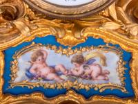 A Louis XV Style Porcelain Mounted Gilt Bronze Figural Mantel Clock