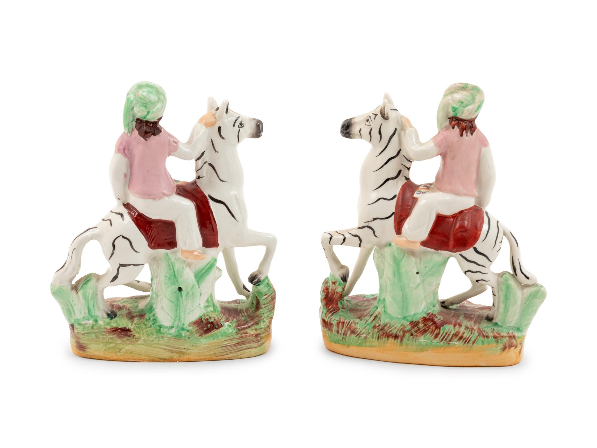 A Pair of Staffordshire Style Figural Groups