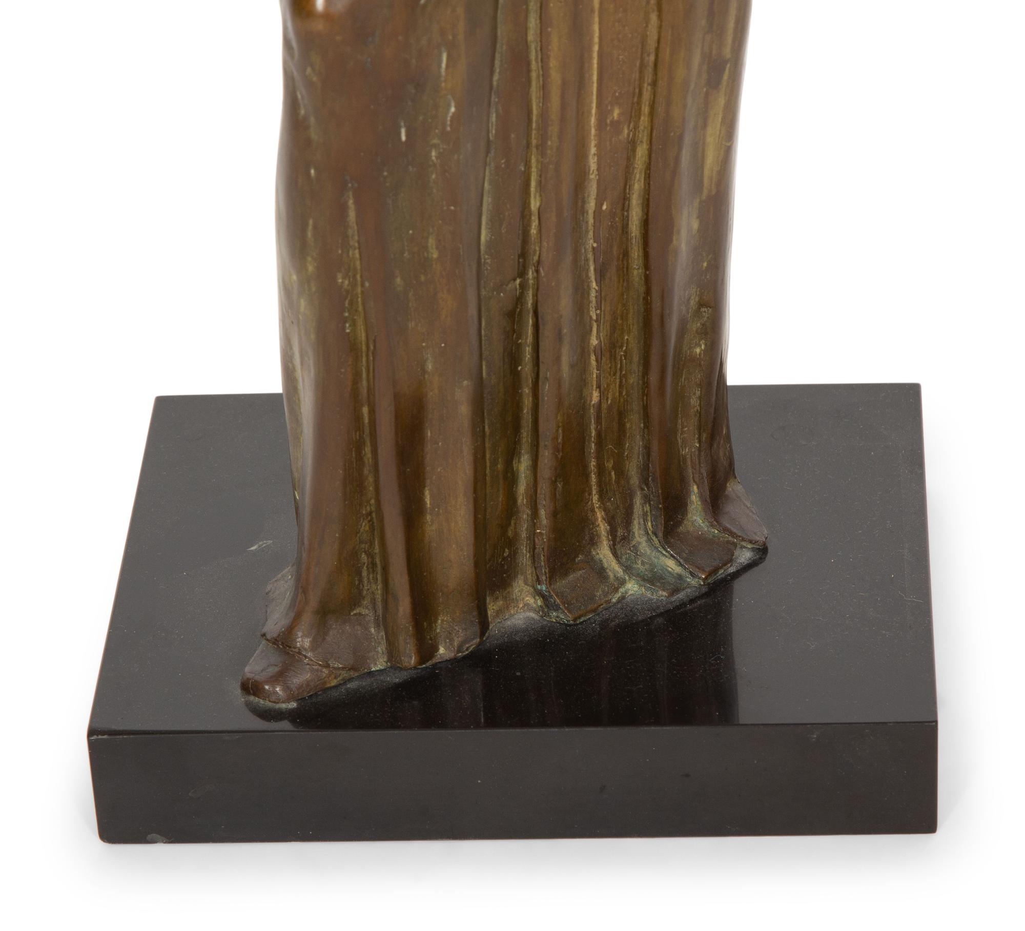 A Bronze Sculpture of a Standing Woman
