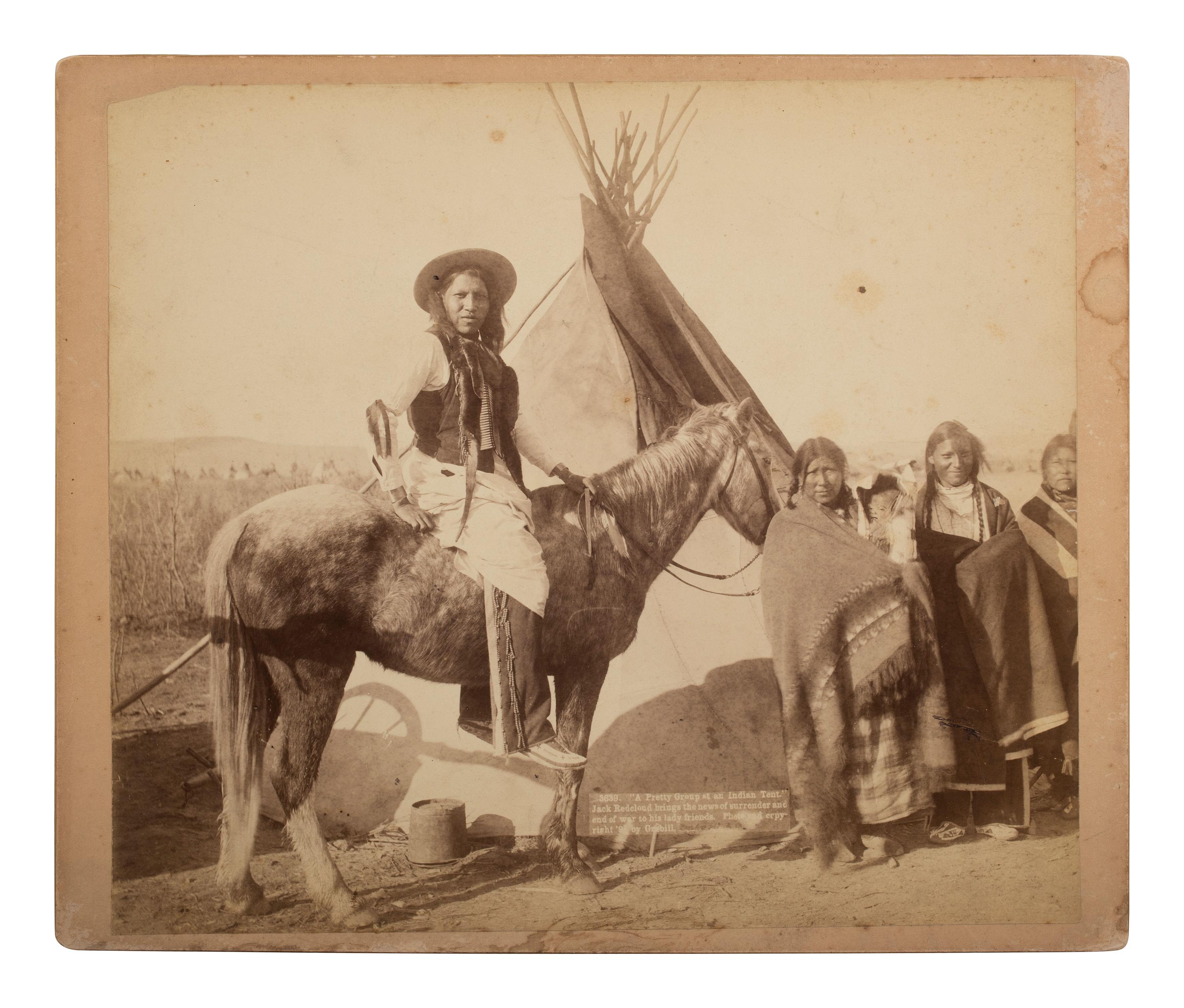 [NATIVE AMERICANS]. GRABILL, John C. (1849-1903), photographer. "A Pretty Group at an Indian Tent." Jack Redcloud brings the news of surrender and end of war to his lady friends . [Deadwood, SD], [1891].