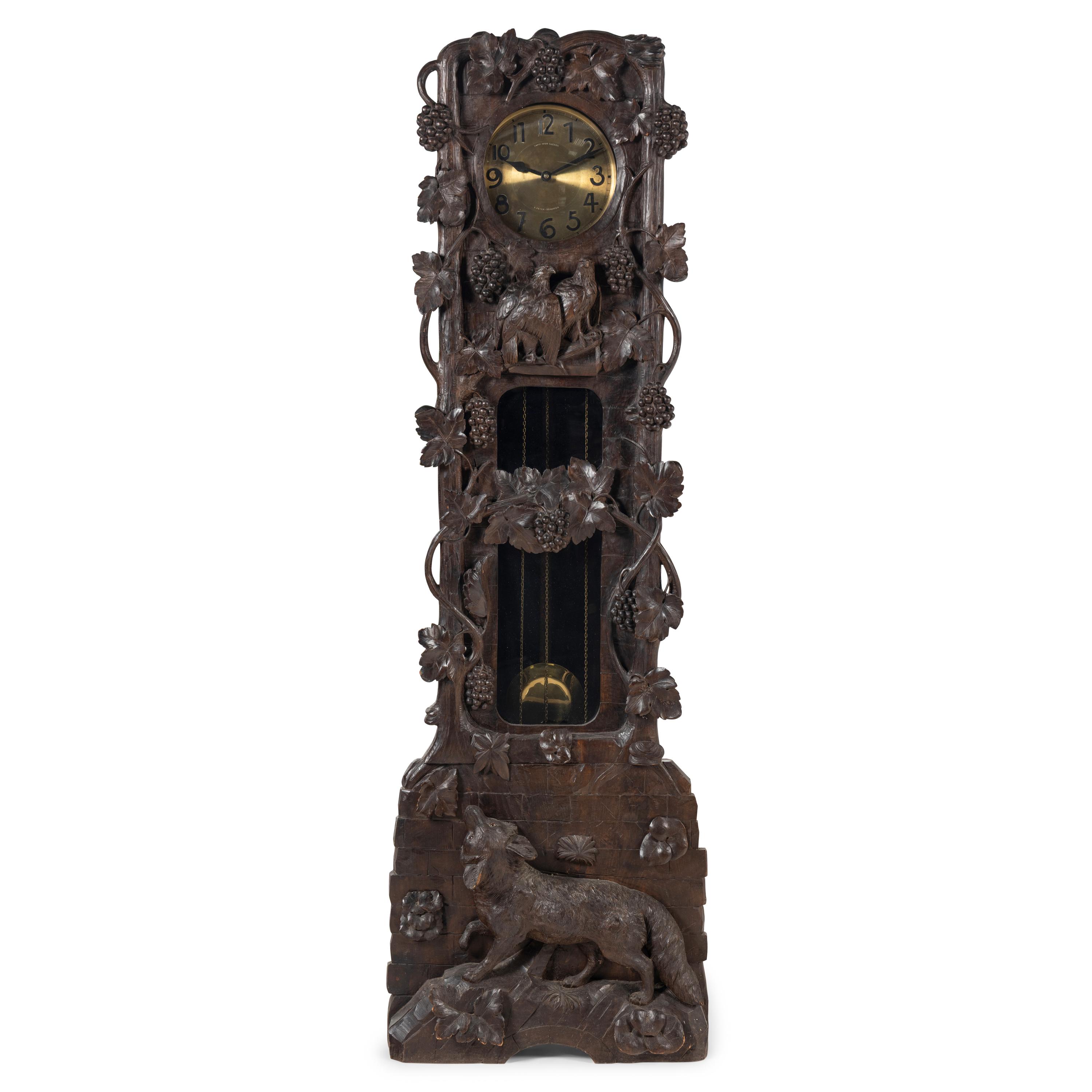 A Swiss Black Forest Carved Tall Case Clock