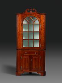 A Late Chippendale Carved Cherrywood Corner Cupboard