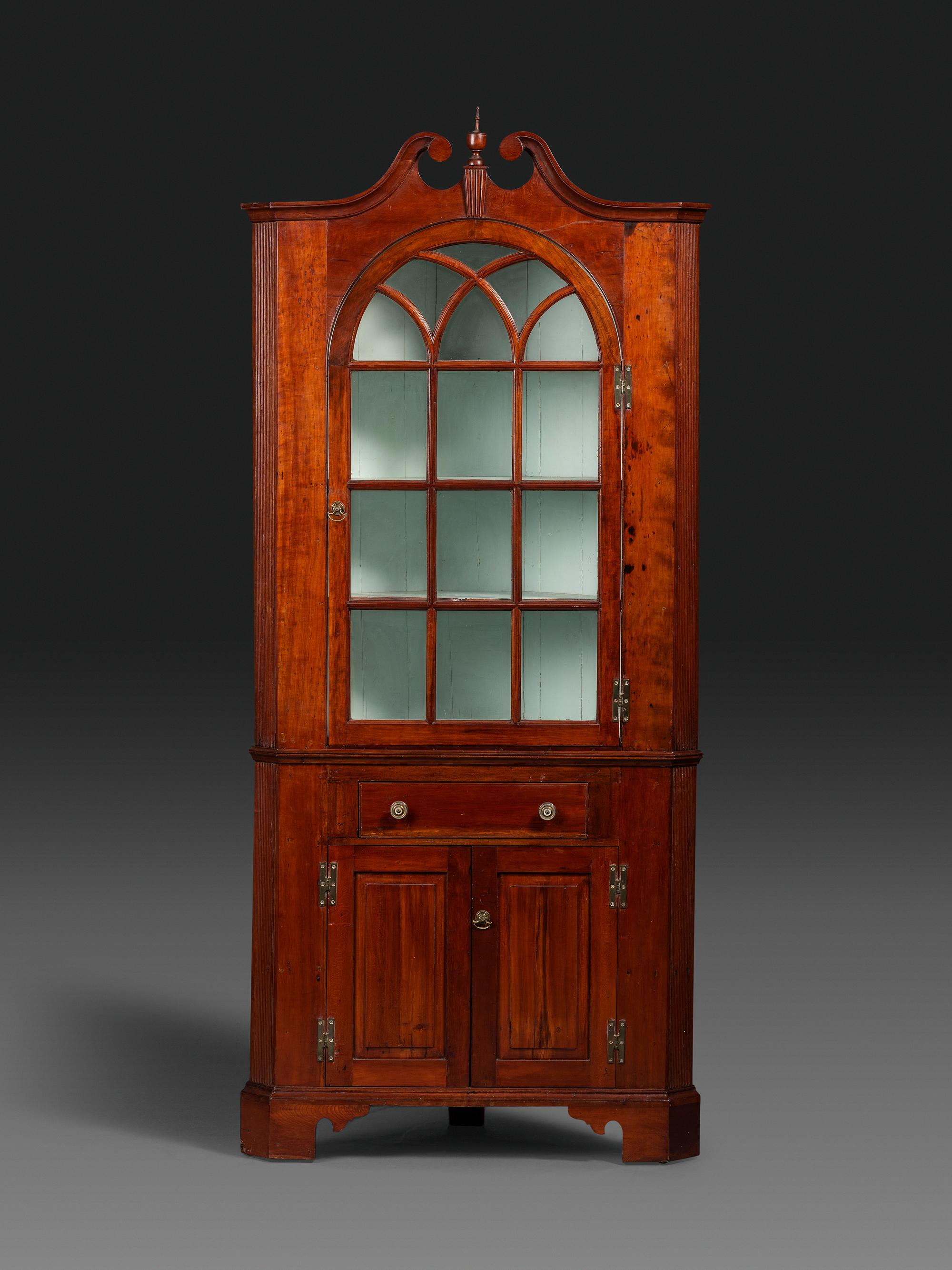 A Late Chippendale Carved Cherrywood Corner Cupboard