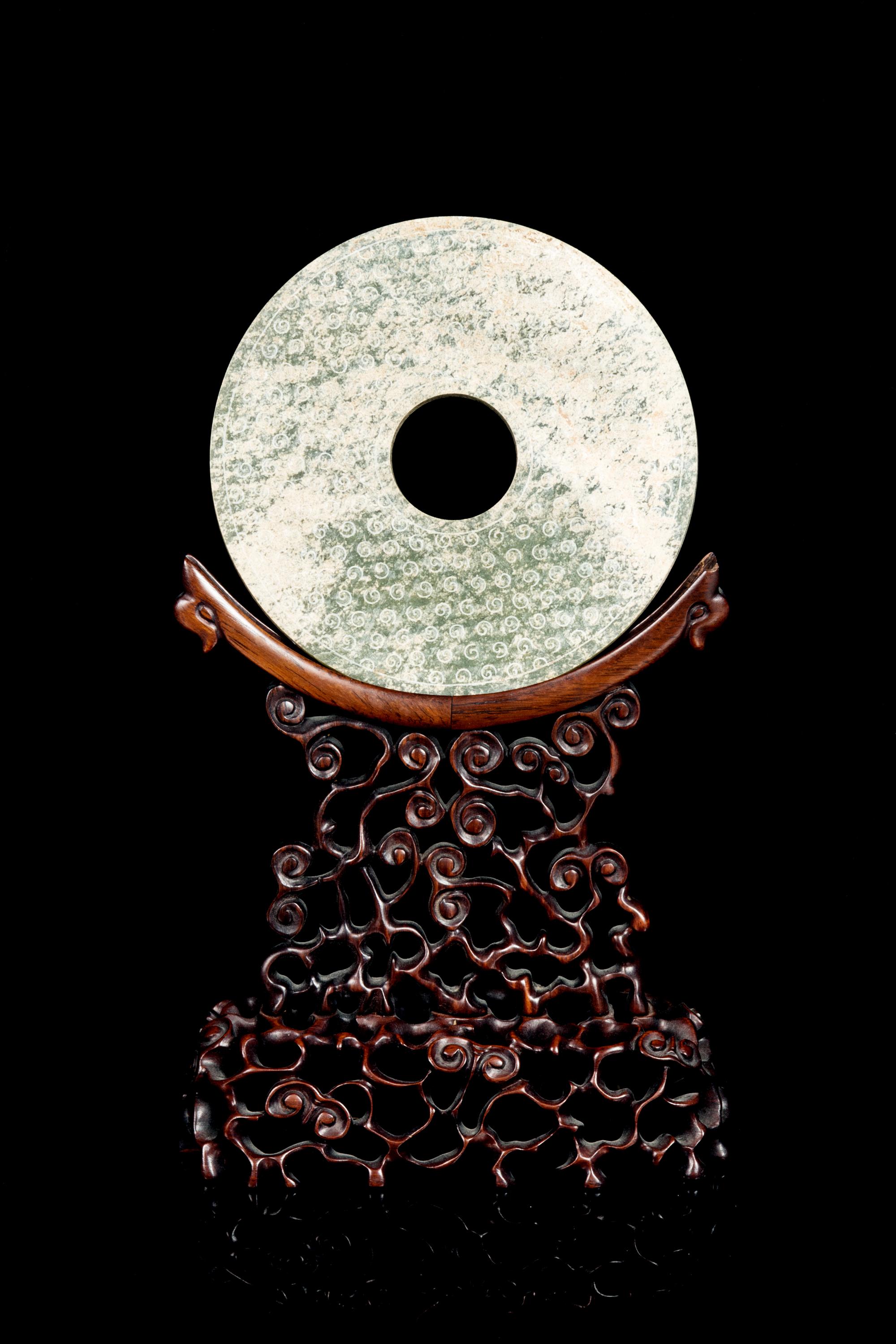 A Chinese Hardstone Bi Disk and Stand Diameter 6 1/2 inches. — LATE 19TH/EARLY 20TH CENTURY