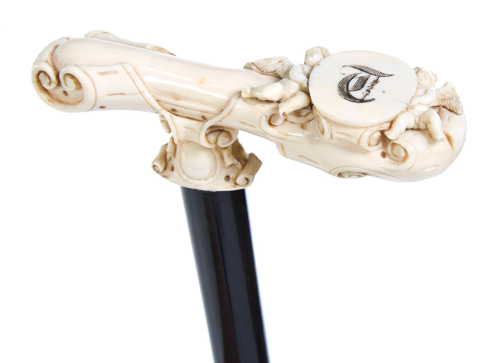 A Continental Carved Ivory Cane Handle, Height overall 38 1/4 x width of handle 5 inches.
