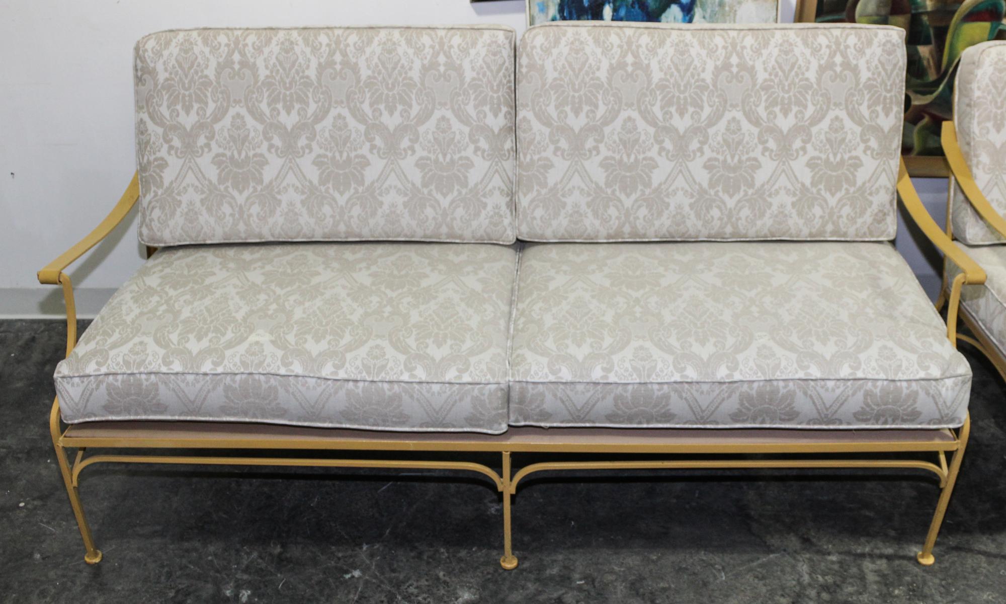 A Pair of Vintage Painted Iron Settees. Height 31 x width 69 x depth 31 1/2 inches.