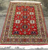 A Group of Four Wool Rugs Dimensions of largest 9 feet 7 inches x 6 feet 4 inches.