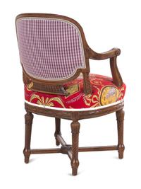 A Louis XVI Style Carved Armchair and Stool with Fortuny Upholstery
