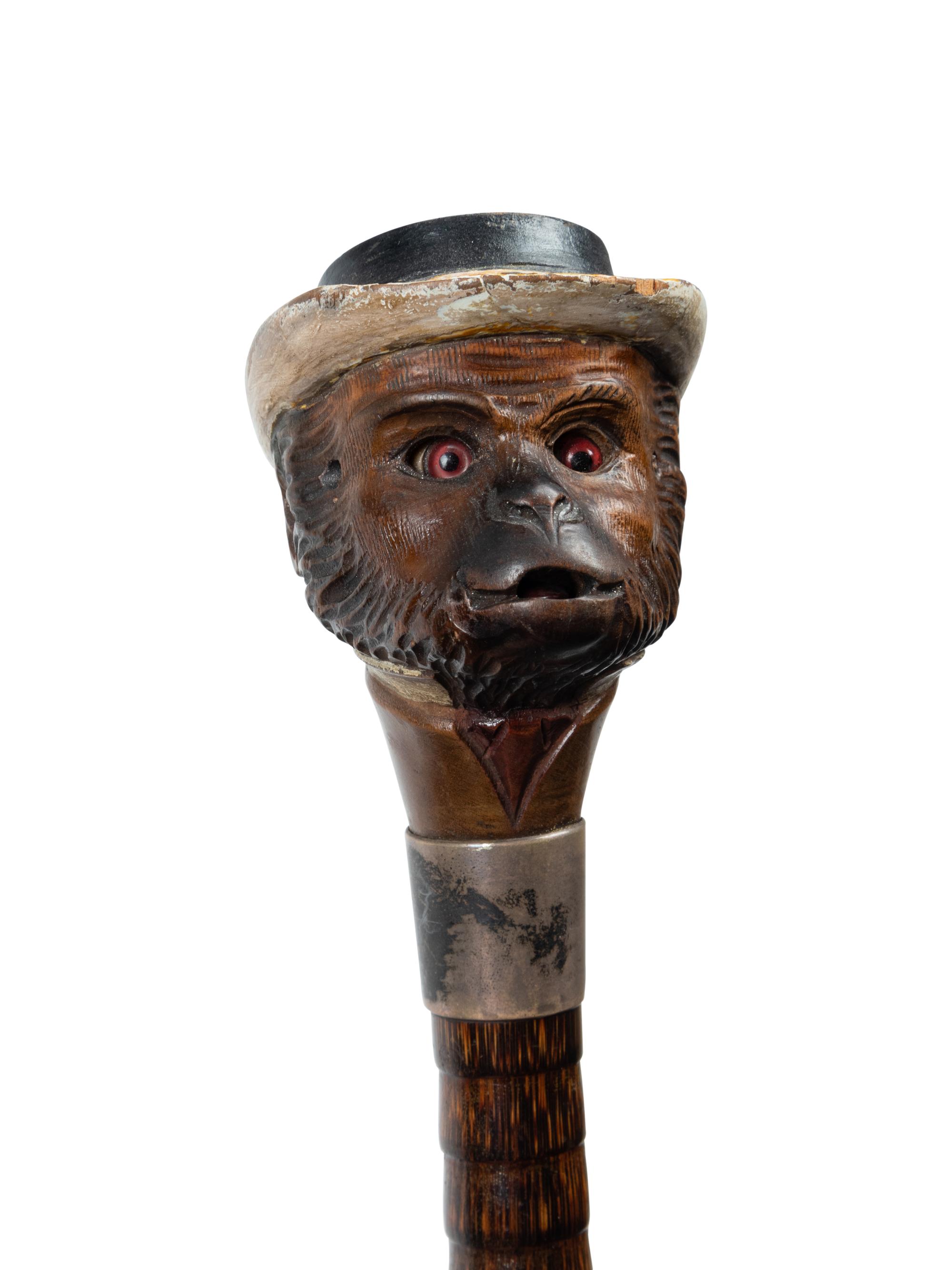 An English Silver and Glass Mounted Carved Wood Automaton Monkey Walking Stick