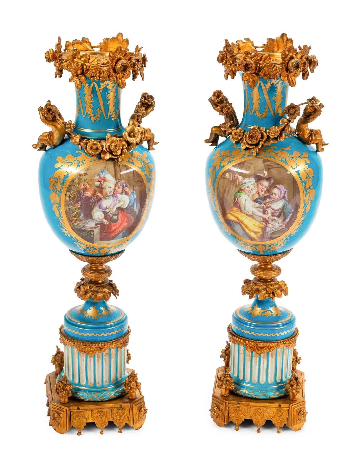 A Pair of Sèvres Style Gilt Bronze Mounted Porcelain Urns