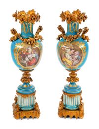 A Pair of Sèvres Style Gilt Bronze Mounted Porcelain Urns