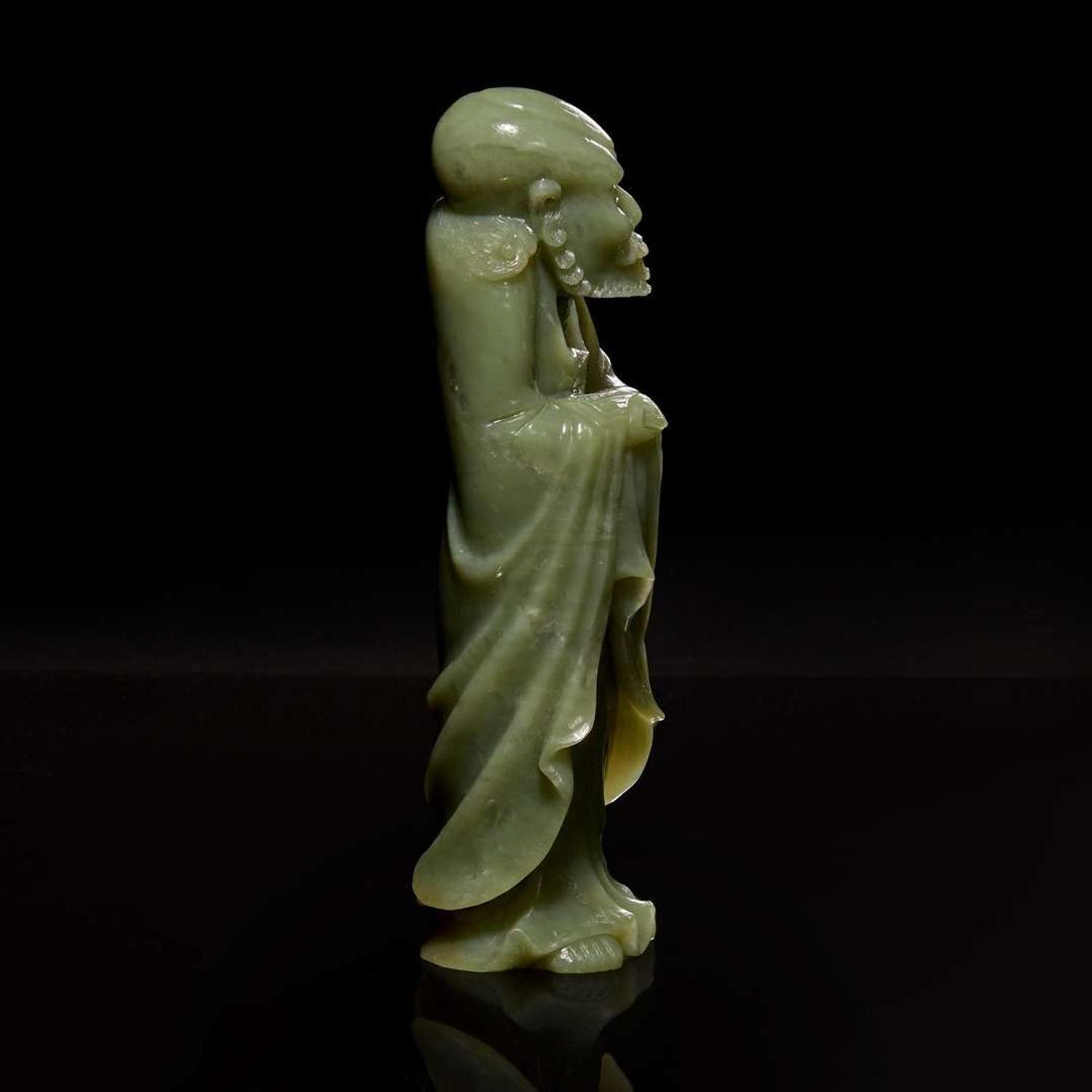 A Chinese carved celadon jade figure of a Lohan 青玉雕羅漢