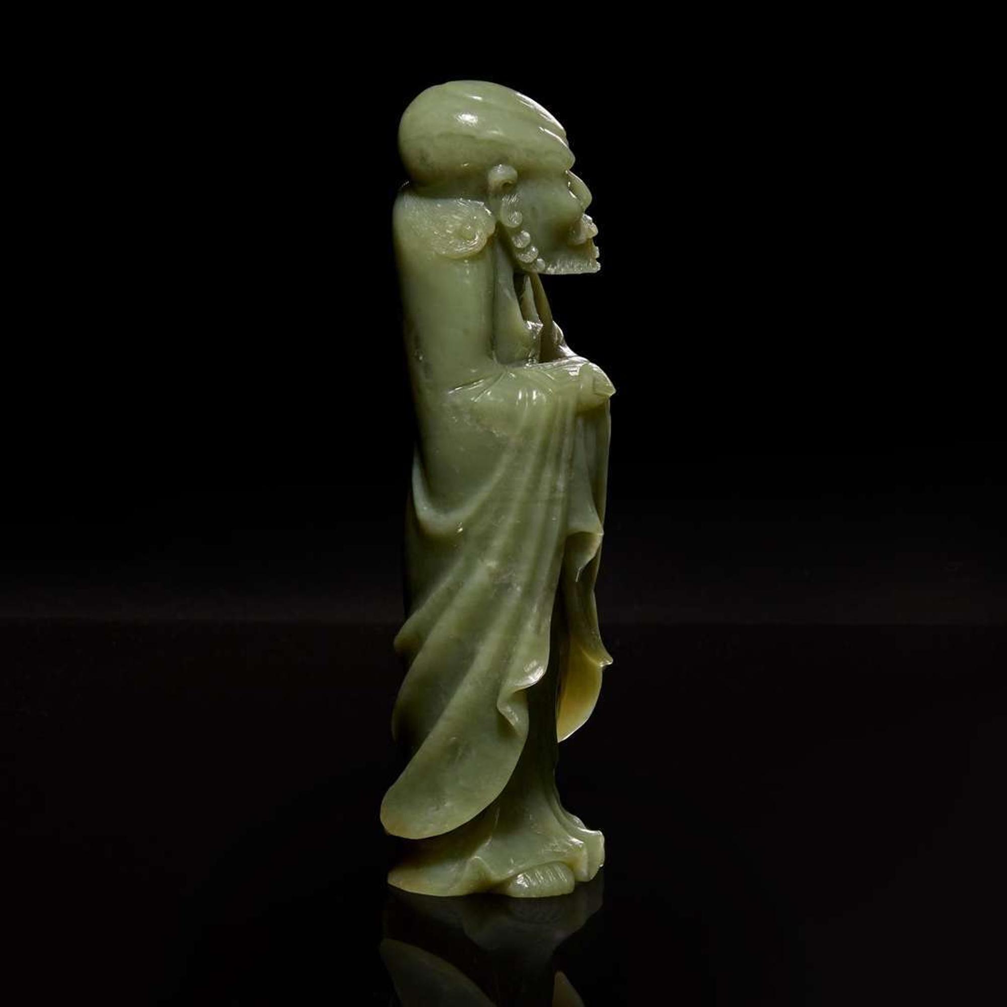 A Chinese carved celadon jade figure of a Lohan 青玉雕羅漢