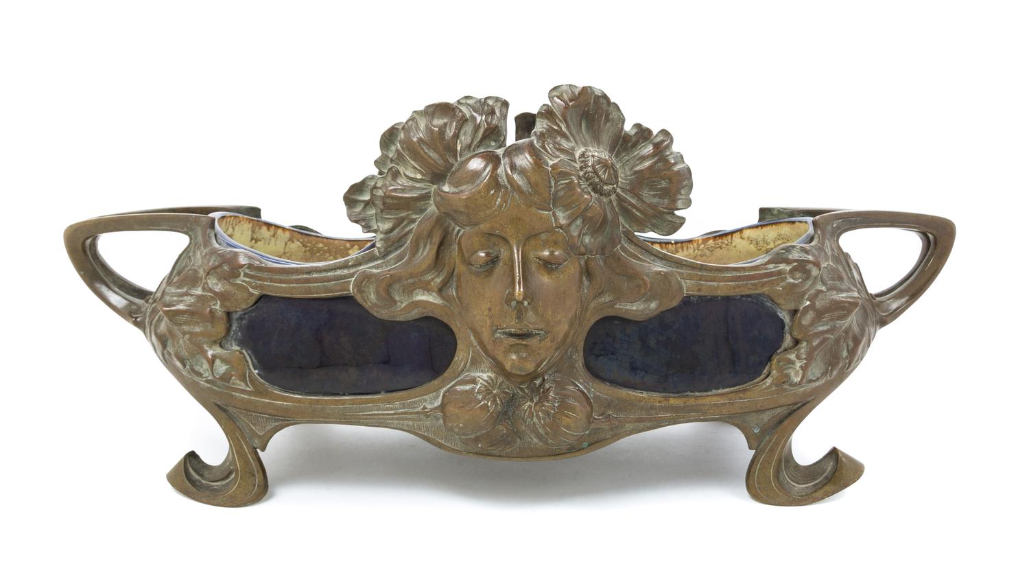 An Art Nouveau Bronze and Ceramic Jardiniere Width over handles 25 1/2 inches.