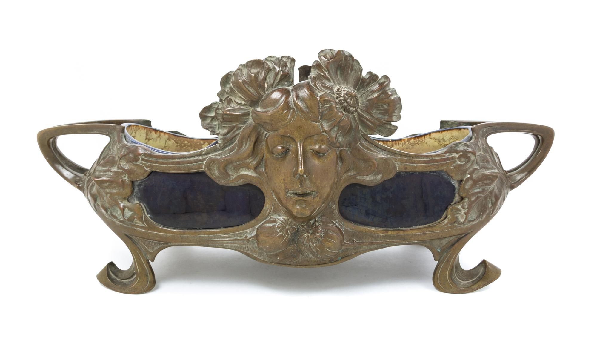 An Art Nouveau Bronze and Ceramic Jardiniere Width over handles 25 1/2 inches.