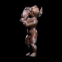 A Roman Bronze Eros with a Dolphin