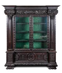 A Continental Carved Oak Display Cabinet Height 86 1/4 x width 70 x depth 25 1/2 inches.