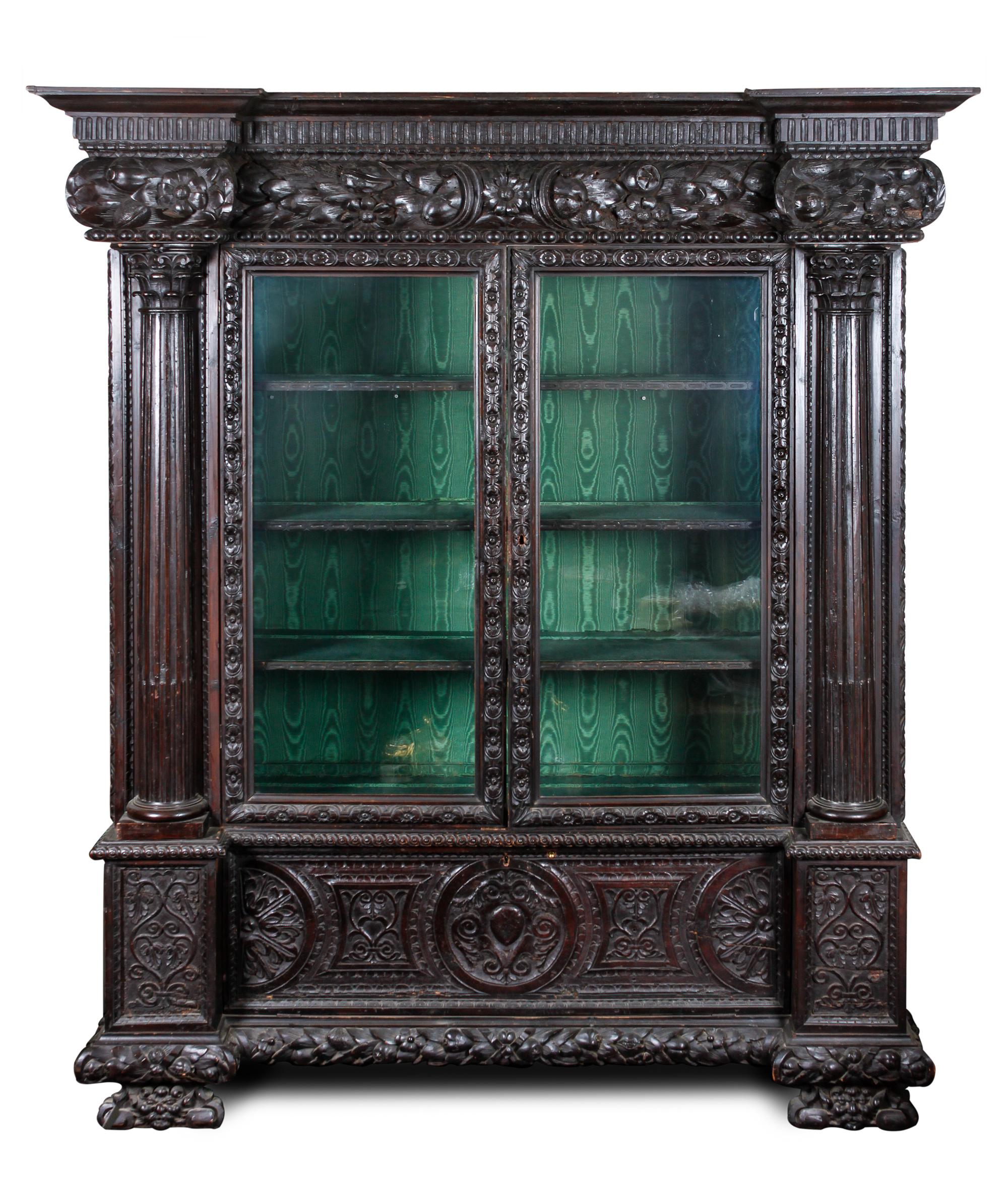 A Continental Carved Oak Display Cabinet Height 86 1/4 x width 70 x depth 25 1/2 inches.