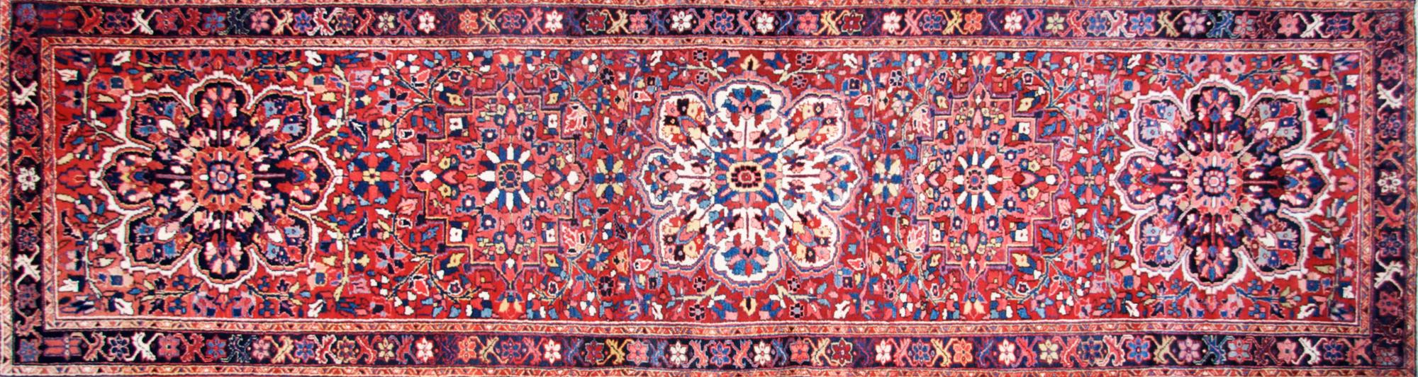 A Heriz Runner. 4 feet x 13 feet 6 inches.