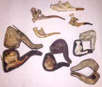 A Collection of Figural Meershaum and Wood Pipes Length of longest 6 inches.