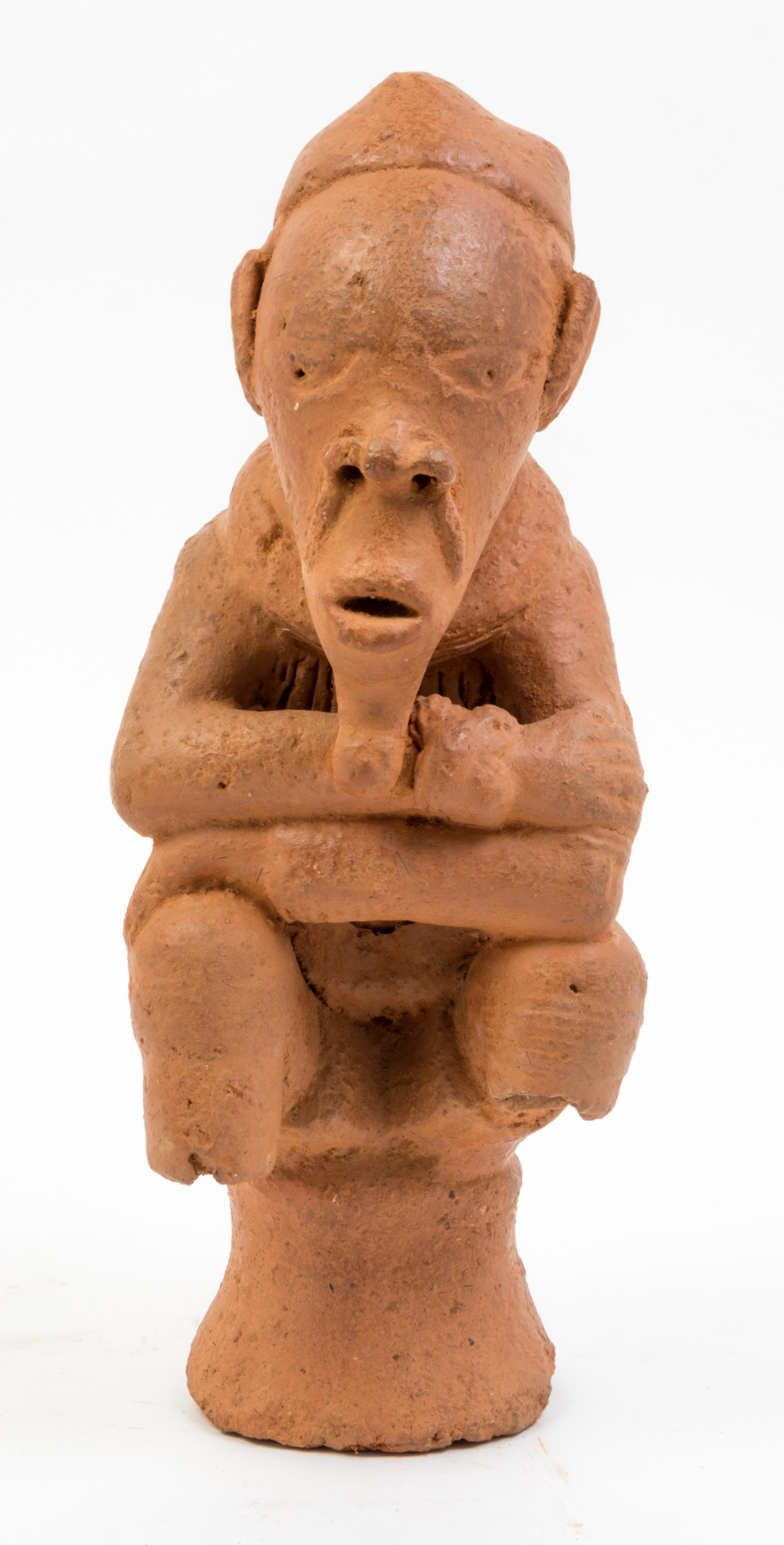 A Nok Style Pottery Figure Height 13 3/4 inches.