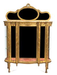 A Louis XVI Style Giltwood Vitrine, Height 67 5/8 x width 49 3/4 x depth 17 5/8 inches.