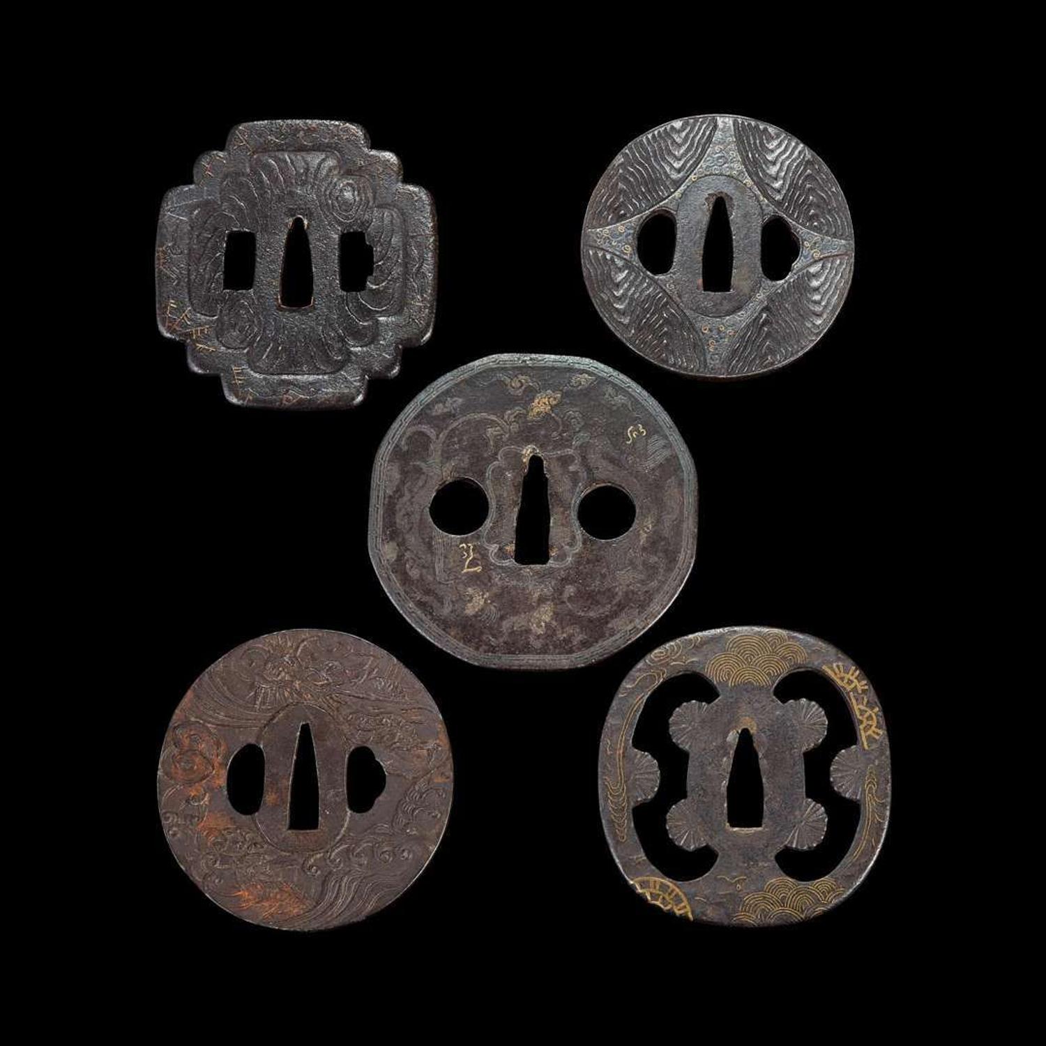 Group of ten Japanese inlaid iron tsuba Edo period or earlier