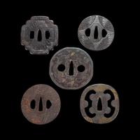 Group of ten Japanese inlaid iron tsuba Edo period or earlier