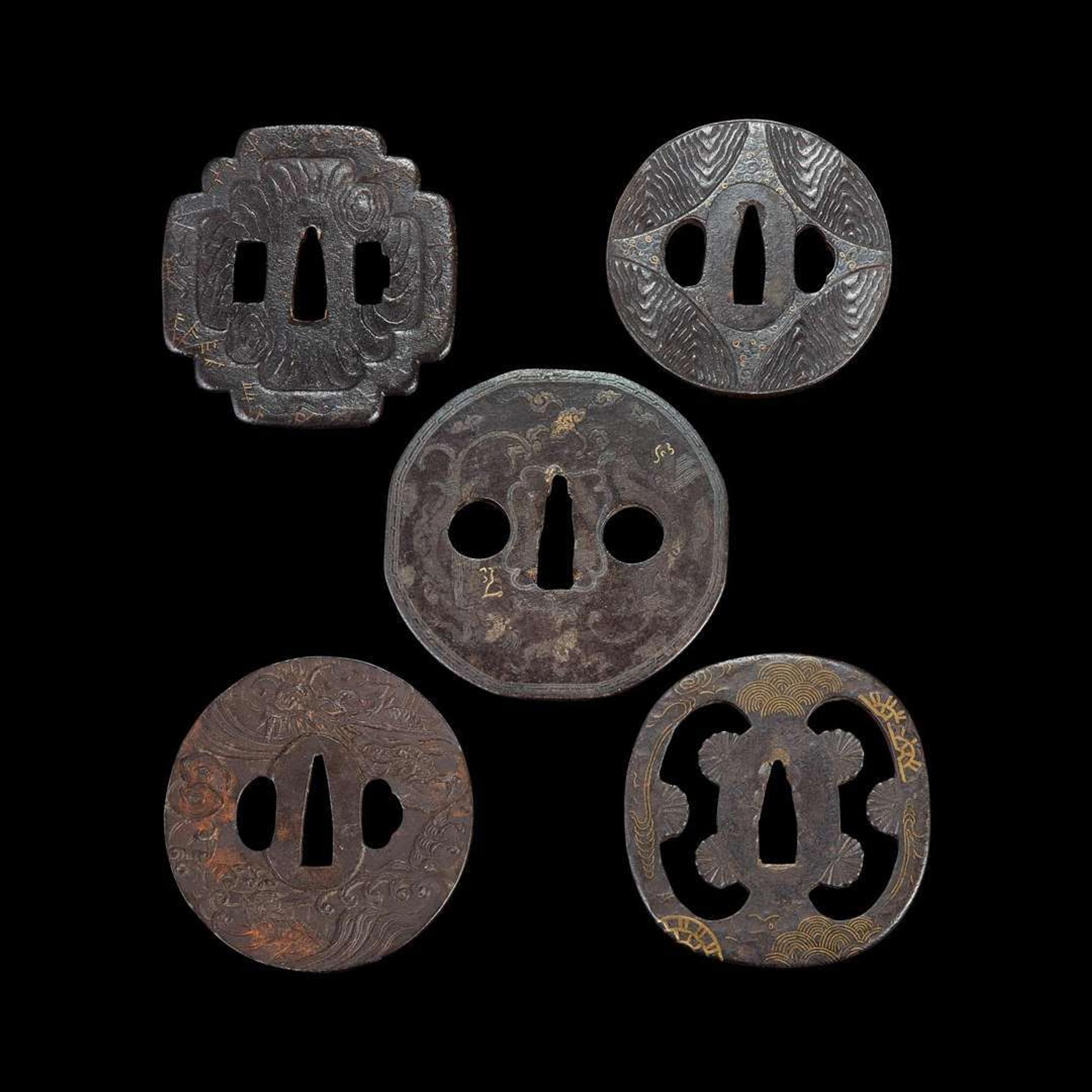 Group of ten Japanese inlaid iron tsuba Edo period or earlier