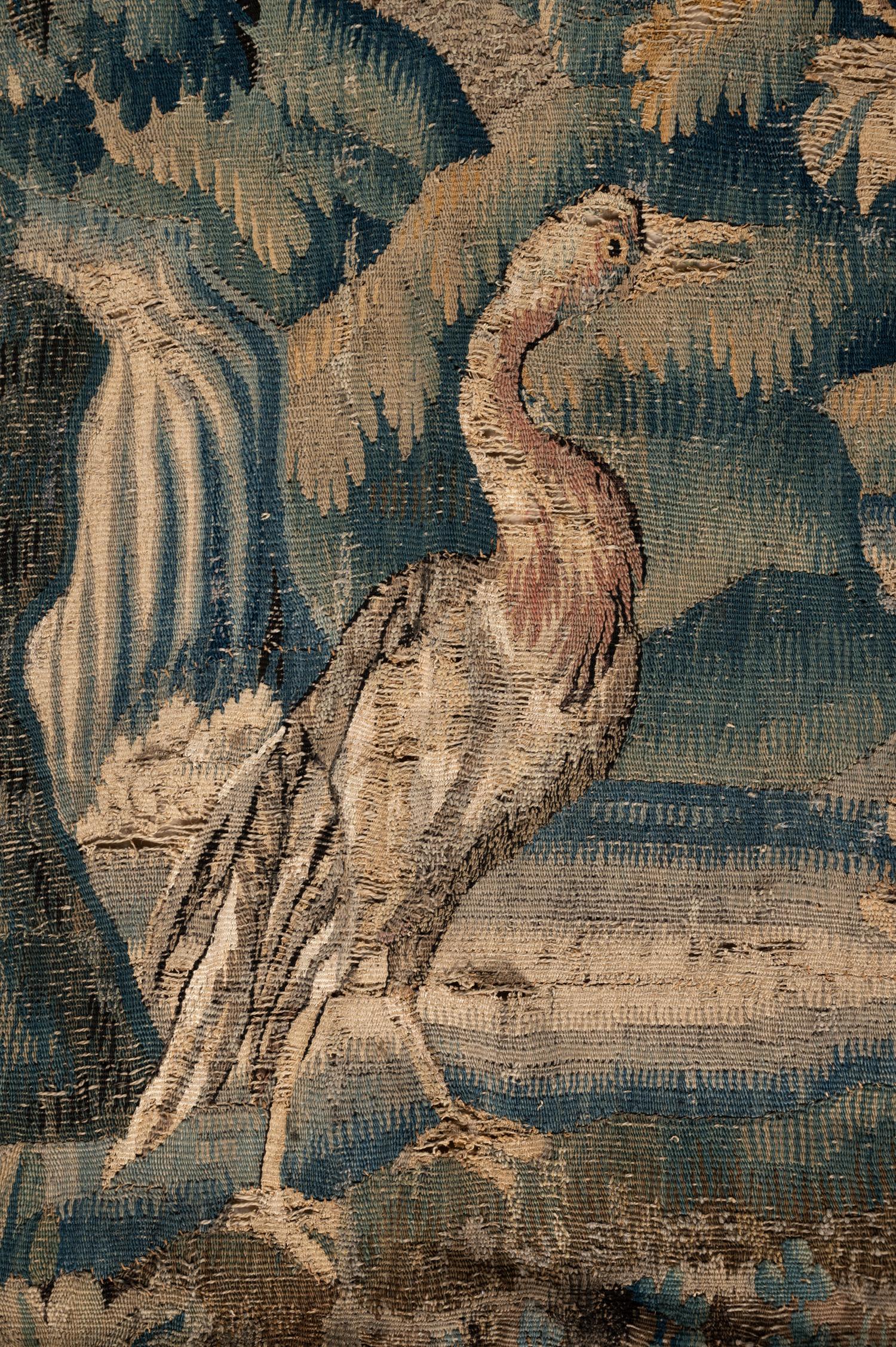 A Continental Wool Verdure Tapestry Fragment