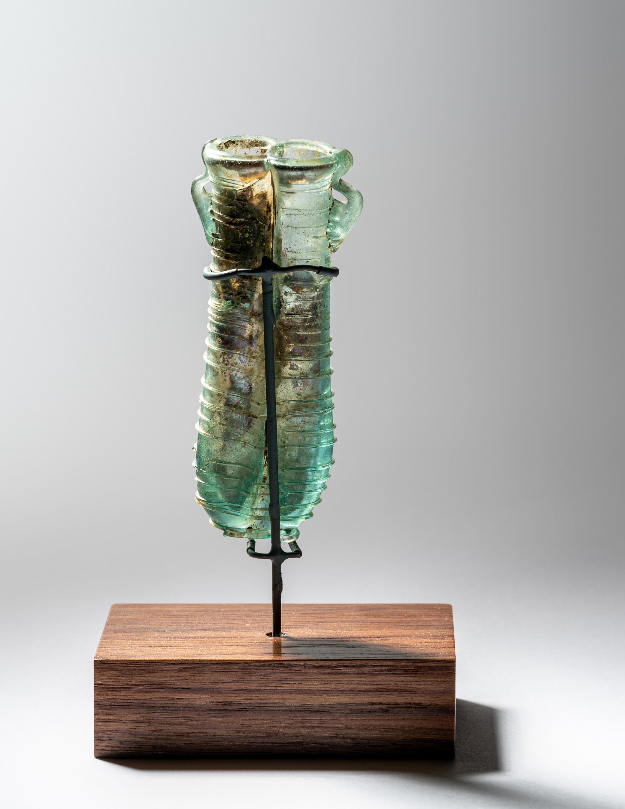 A Roman Pale Blue Glass Double Unguentarium