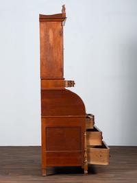 A Late Federal Cherry Wood and Tiger Maple Roll-Top Desk-and-Bookcase