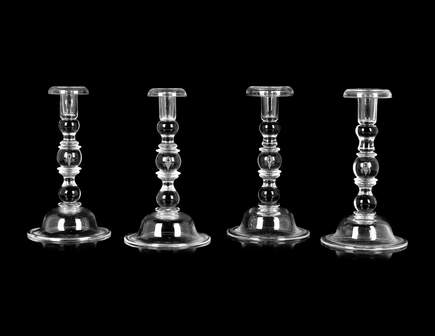 A Set of Four Steuben Glass Candlesticks