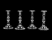 A Set of Four Steuben Glass Candlesticks