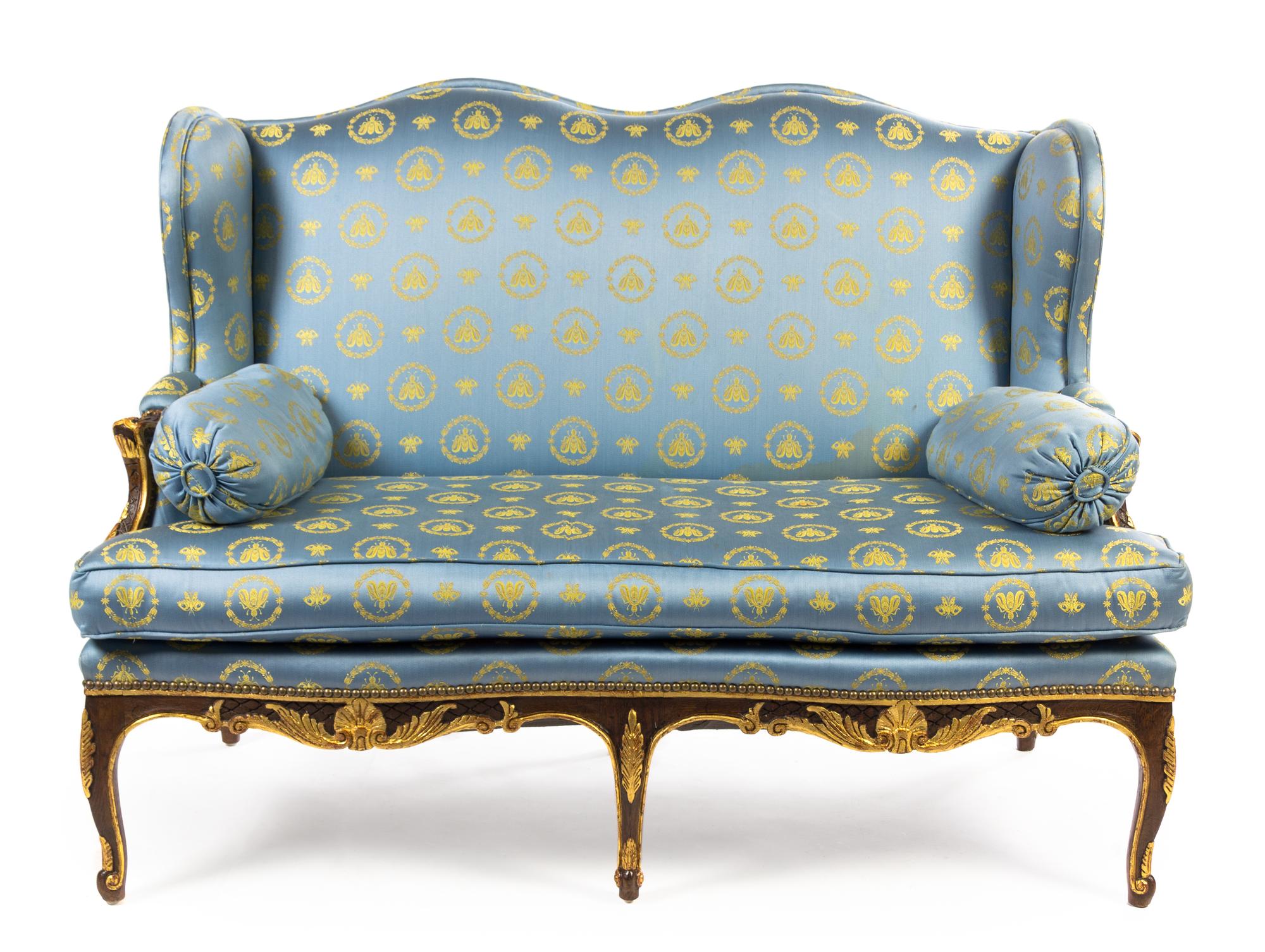 A Pair of Louis XV Style Parcel Gilt Oak Canapes a Oreilles Height 41 1/2 x width 52 1/4 x depth 31 inches. — LATE 19TH CENTURY