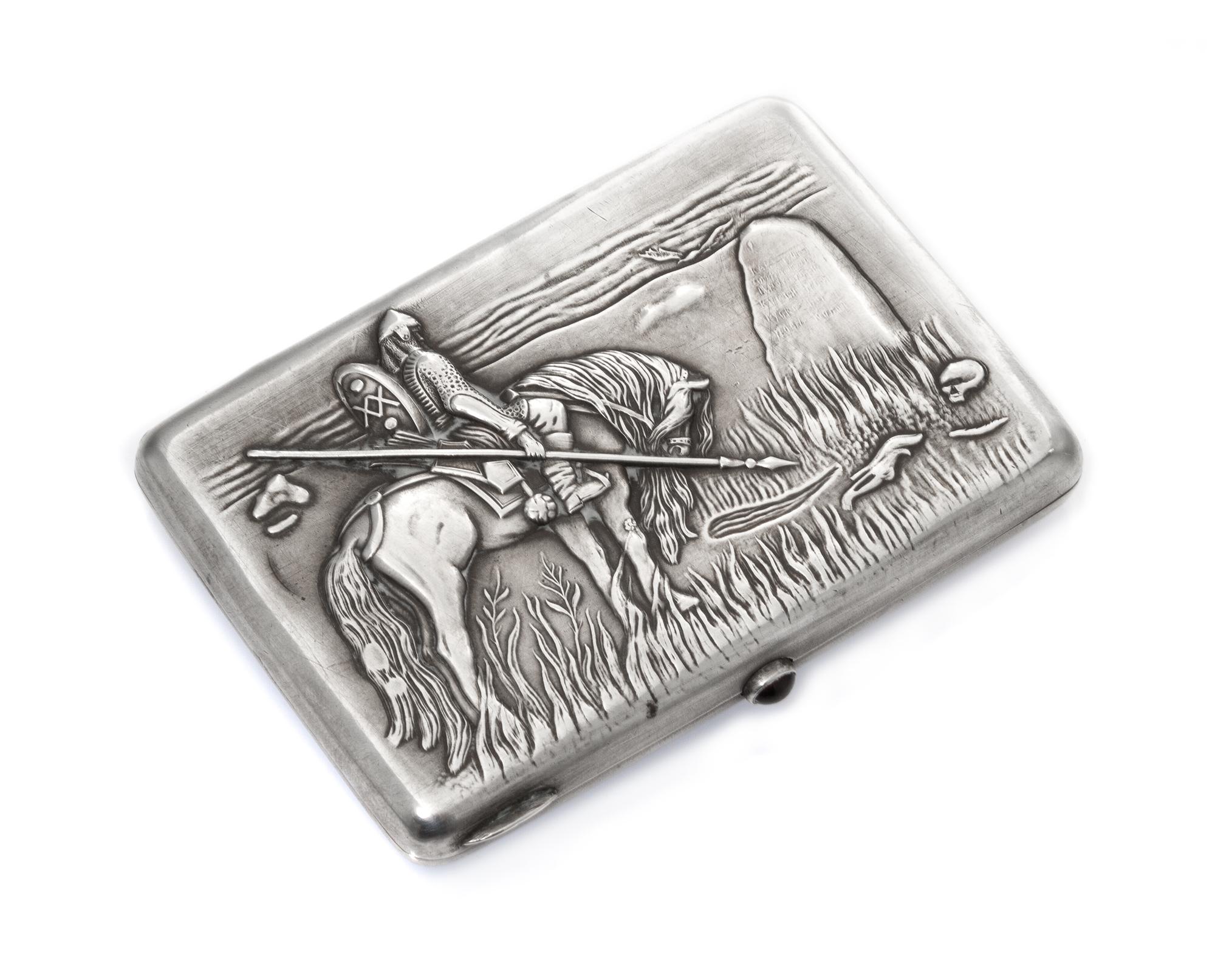 A Russian Silver Cigarette Case, Maker's mark Cyrillic GE, Moscow, the lid worked to show a warrior on horseback mourning at a gravesto