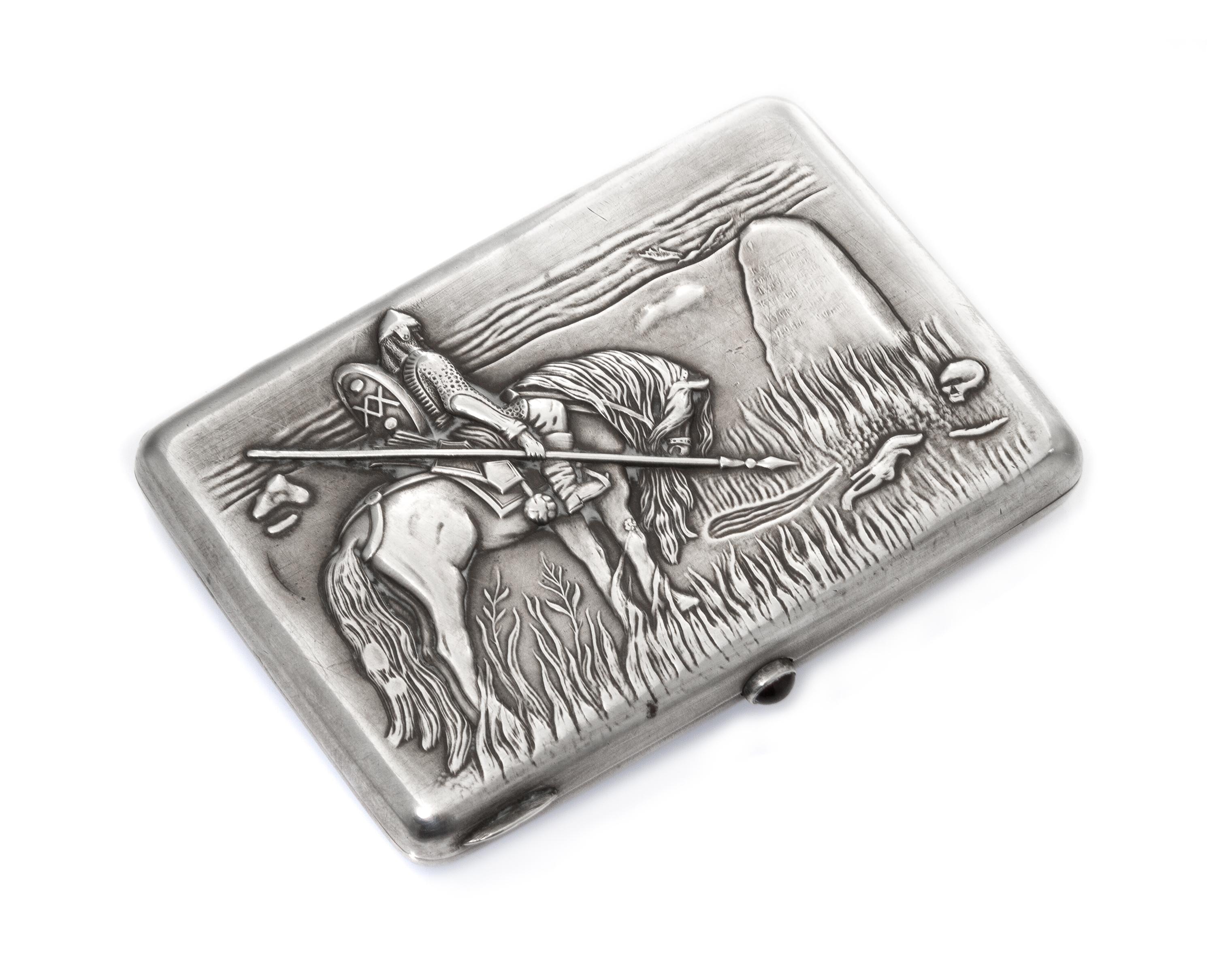 A Russian Silver Cigarette Case, Maker's mark Cyrillic GE, Moscow, the lid worked to show a warrior on horseback mourning at a gravesto