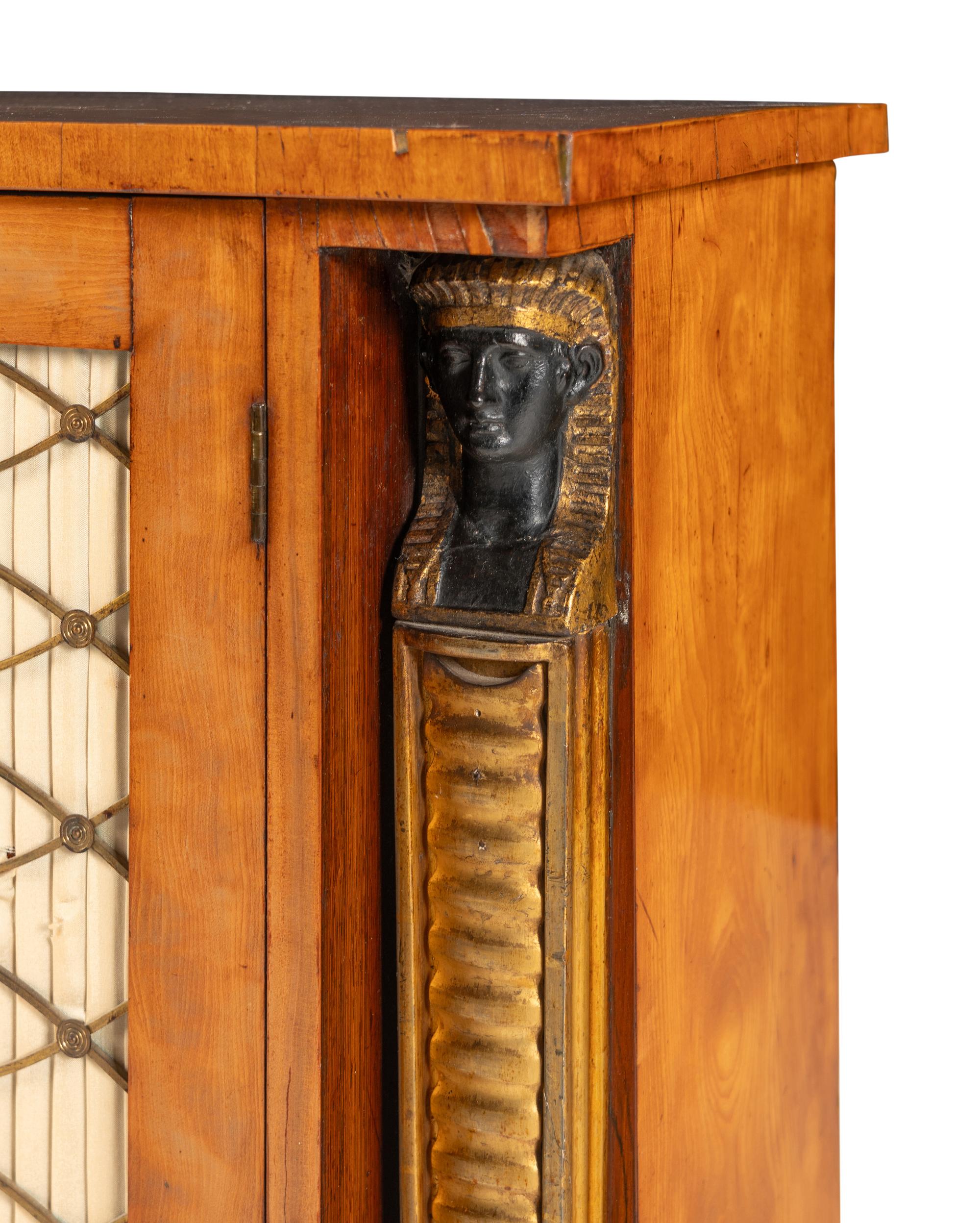 A Regency Satinwood, Part Ebonized and Parcel Gilt Cabinet