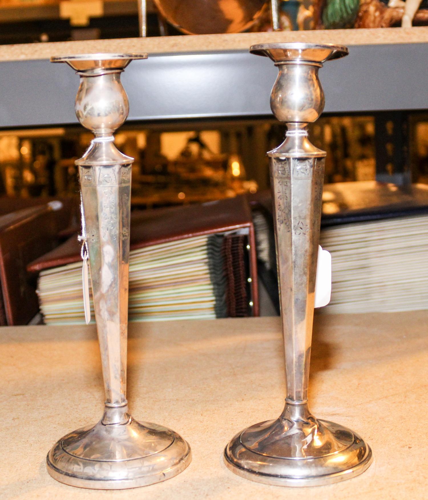 A Pair of American Silver Candlesticks, makers mark obscured, having a baluster form cup surmounting an octagonal tapering stem chased