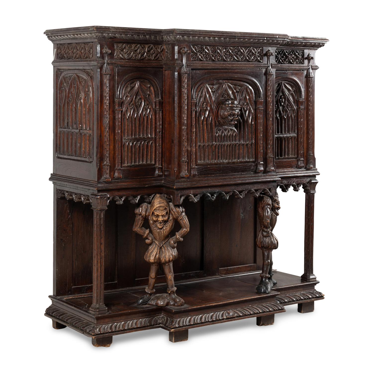 A Gothic Revival Carved Oak Court Cupboard