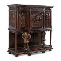A Gothic Revival Carved Oak Court Cupboard