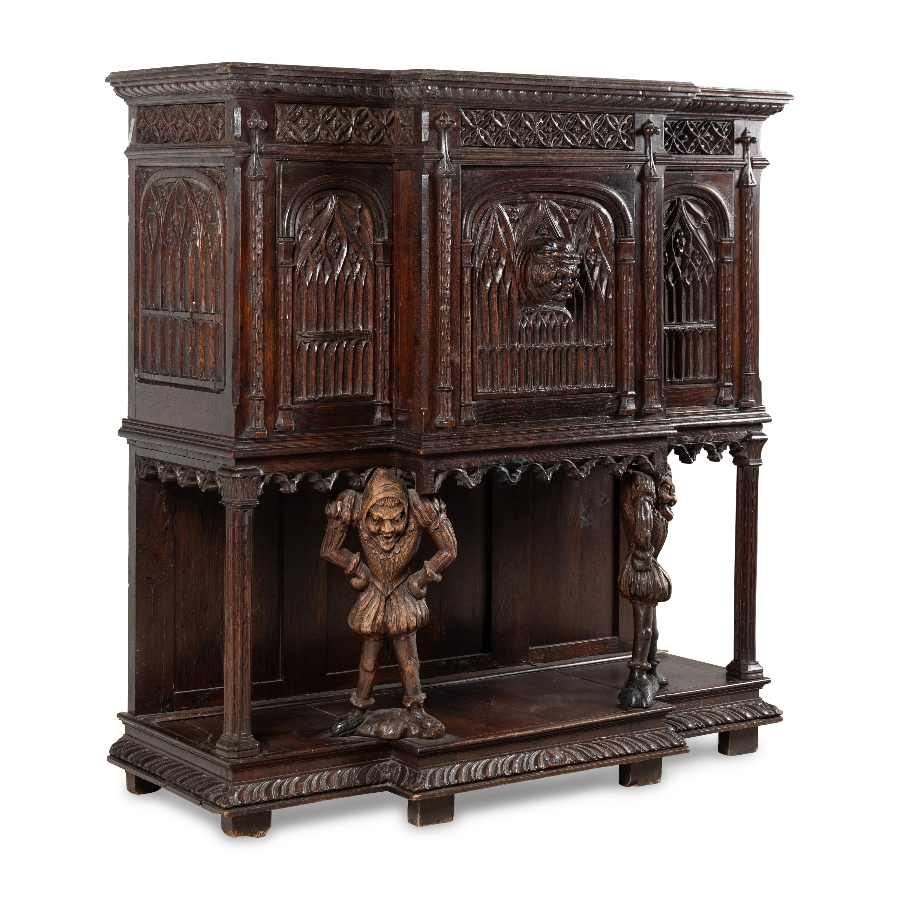 A Gothic Revival Carved Oak Court Cupboard