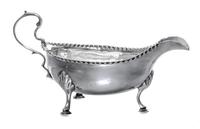 A George III Silver Sauce Boat, Hester Bateman, London, 1781, having a double scroll handle and a beaded edge, raised on foliate worked