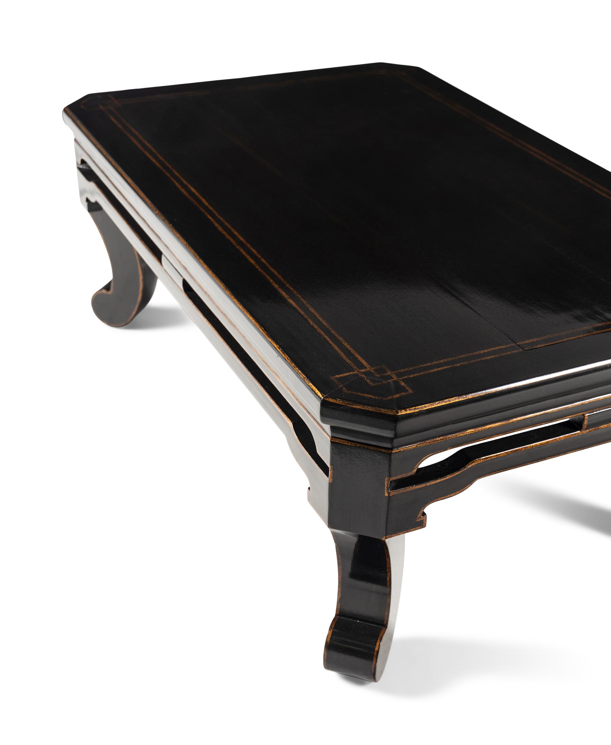 A Contemporary Black Lacquered and Parcel Gilt Low Table
